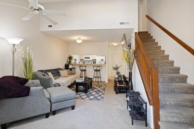 Carpeted living room with ceiling fan