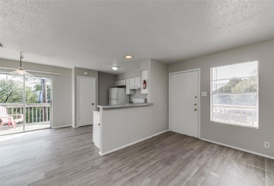 Unfurnished living room with baseboards, a textur