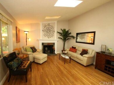 Beautiful living room with skylights and hardwood 