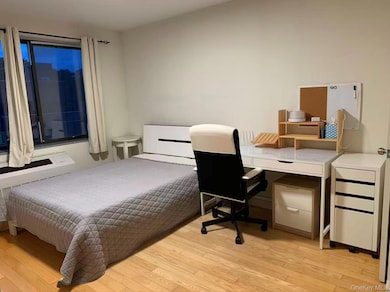 Bedroom featuring light wood-style flooring and an office area