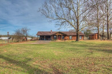 exterior with mature trees and storage shed