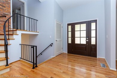 Foyer entrance featuring stairs and light wood finished floors