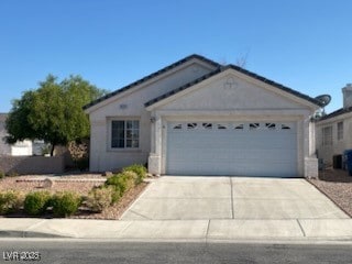 Single story home with concrete driveway and an at
