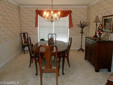 Dining Room. Crown and chair molding ennhance the formal dining room.