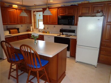 The spacious Kitchen has beautiful maple cabinetry