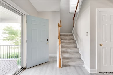 Foyer entrance with plenty of natural light, stair