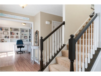 The foyer entry has an open stair case and French 