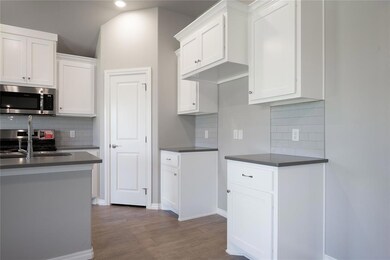 Kitchen featuring stainless steel appliances, whit