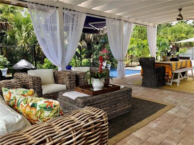 Fenced backyard with an outdoor living space, a patio, outdoor dining space, and ceiling fan
