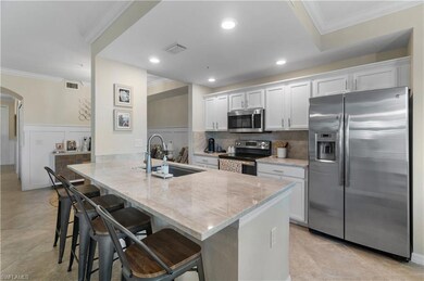 Kitchen with white cabinetry, kitchen peninsula, s