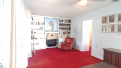 Living room with built-in bookshelves and fireplac