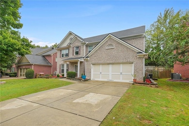 View of front of property with driveway, brick siding, and an attached garage