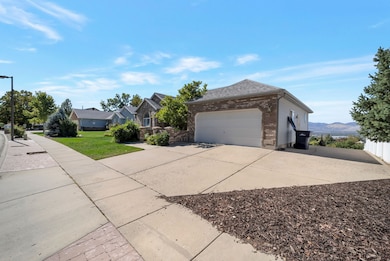 View of front of home featuring concrete driveway, brick siding, a front yard, an attached garage, and a residential view