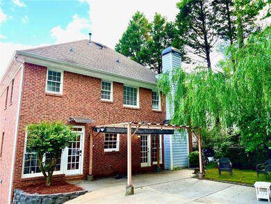 Back of house with a pergola, a patio area, a chim