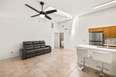 Living room with baseboards, a ceiling fan, visibl