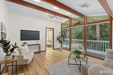 Floor-to-ceiling windows in the living room offer unobstructed views of the surrounding landscape. Enjoy a bright, modern space that feels connected to nature!