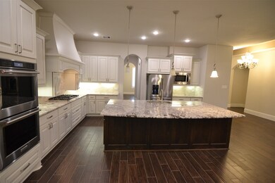 This photo shows the kitchen and the Huge Reception Foyer that leads into it, with Dining Room, Study, and 2nd Bedroom, along the way from the Front Door.