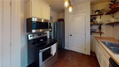 Kitchen with Pantry and Stainless Steel Appliances.