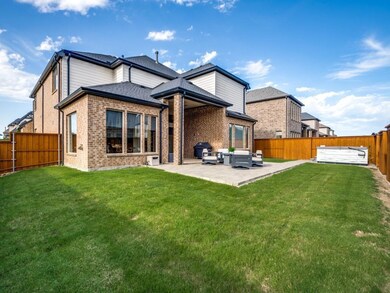 Back of property with a patio and a lawn