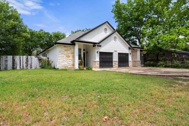View of front of property featuring driveway, a f
