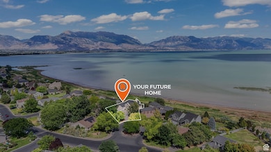 Aerial view of residential area with a water and mountain view and property parcel outlined