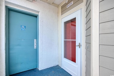 Entrance to property with stucco siding