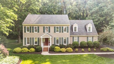 Colonial home featuring a front yard