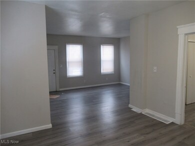 Unfurnished room with dark hardwood / wood-style floors