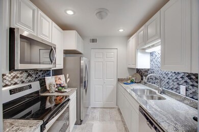 Kitchen with new stove, fridge, disposal, granite, back splash