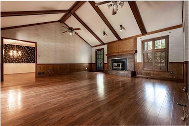 Great room has wood burning stove and access to a large wood deck