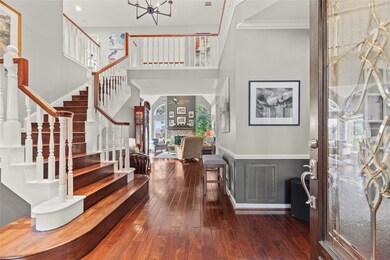 Inviting front entry with gorgeous wood flooring,
