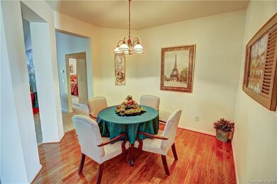 Unique formal dining room with hardwood flooring.