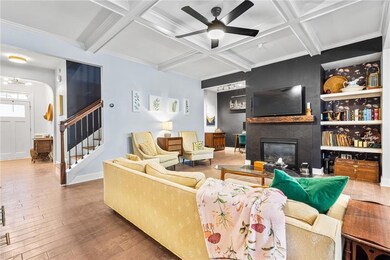 Stylish details like hardwood flooring, coffered c