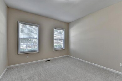 Empty room featuring healthy amount of natural light and carpet floors