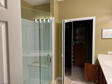 Full bathroom with a shower stall and vanity