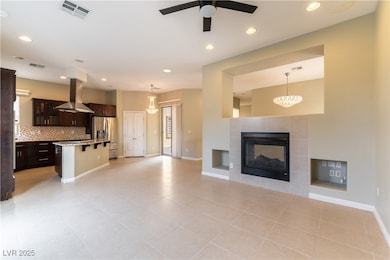 Unfurnished living room featuring ceiling fan, lig