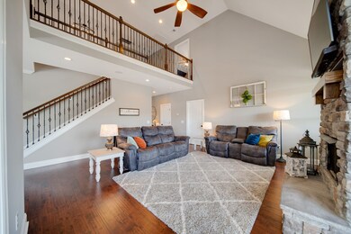 Huge Living room with stone fireplace, hardwood flooring and beautiful neutral colors throughout. 