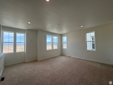 Spare room with light colored carpet, recessed lighting, and a textured ceiling