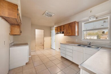 Kitchen featuring light tile patterned floors, whi