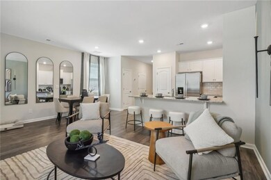 Living area featuring dark wood finished floors, recessed lighting, and baseboards