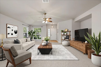 Living area with a ceiling fan and baseboards