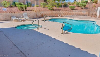 Community pool featuring a hot tub and a patio area