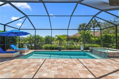 Outdoor pool featuring glass enclosure and a patio