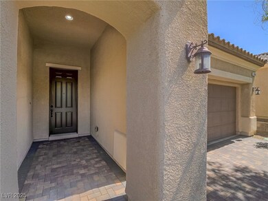 Entrance to property with stucco siding and a tile