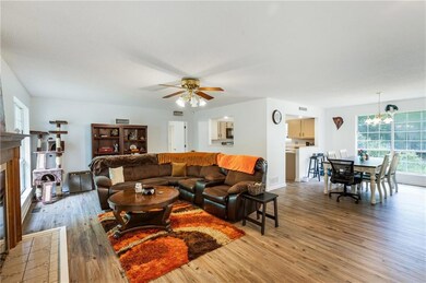 Living room featuring visible vents, light wood-st