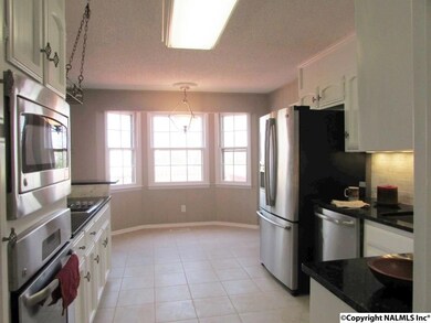 The breakfast nook features a bay window overlooking the back yard.