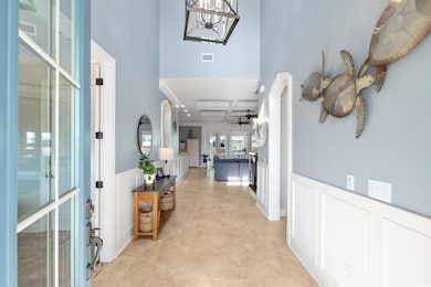 Foyer featuring a wainscoted wall, visible vents, 