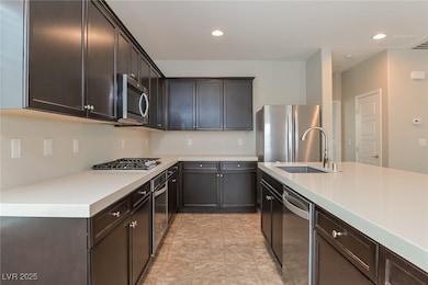 Kitchen featuring stainless steel appliances, a si