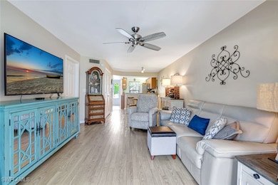 Living area with light wood-style flooring and ceiling fan