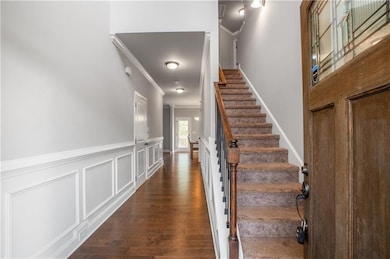 Entrance foyer with stairs, wainscoting, crown mol